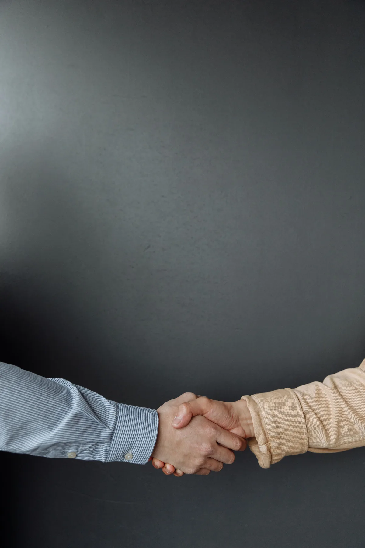 Two people shaking hands after a successful referral.