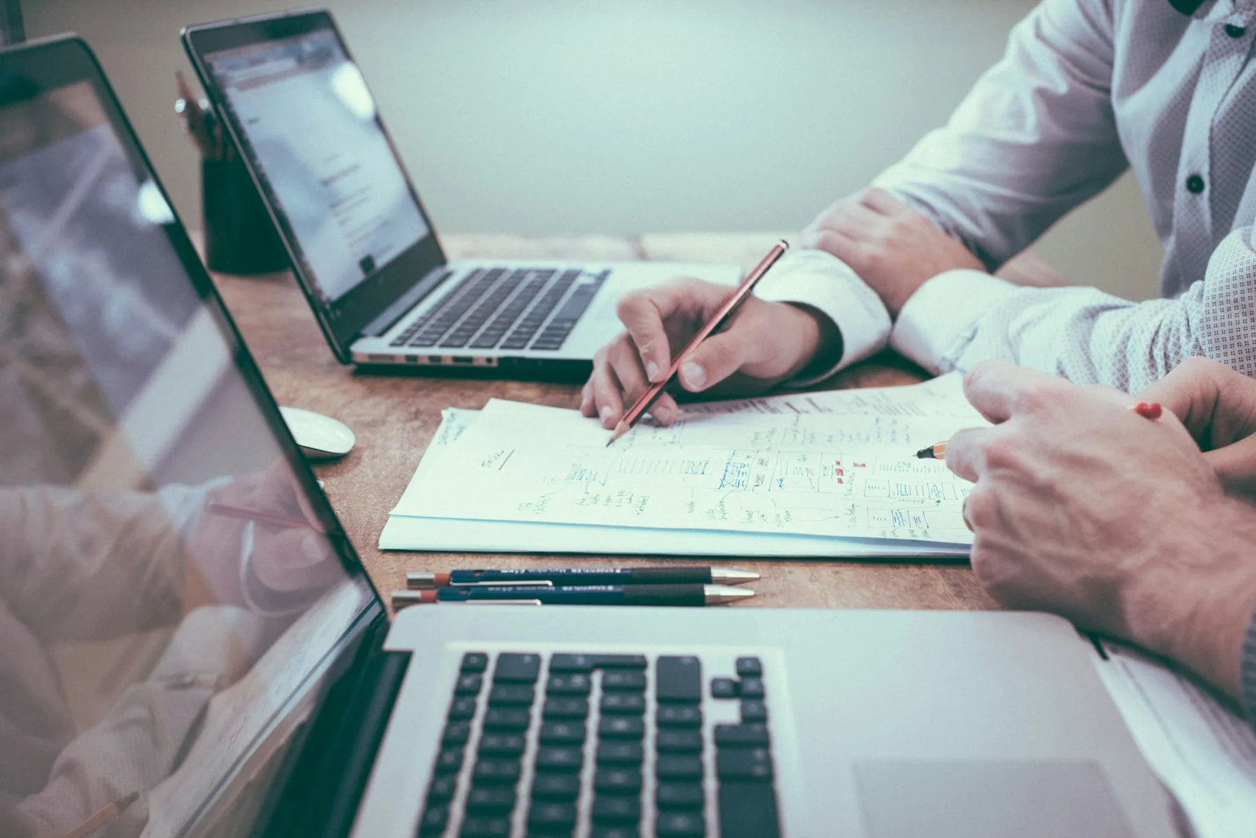A desk with financial documents, planning notes, and a calculator.